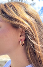 Load image into Gallery viewer, Model wearing 4mm Old English Medium Hoop Earrings with Post in 14K Pink Gold