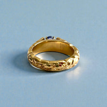 Load image into Gallery viewer, Scalloped Hibiscus 6mm Tapered French Mount Solitaire Ring with Oval Tanzanite in 14K Yellow Gold in size 6 3/4
