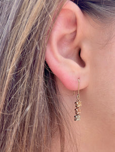 Model wearing Tri-Color Three Baby Plumerias Dangle Earrings in 14K Gold